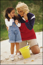 (image of child and grandmother at play on the beach)